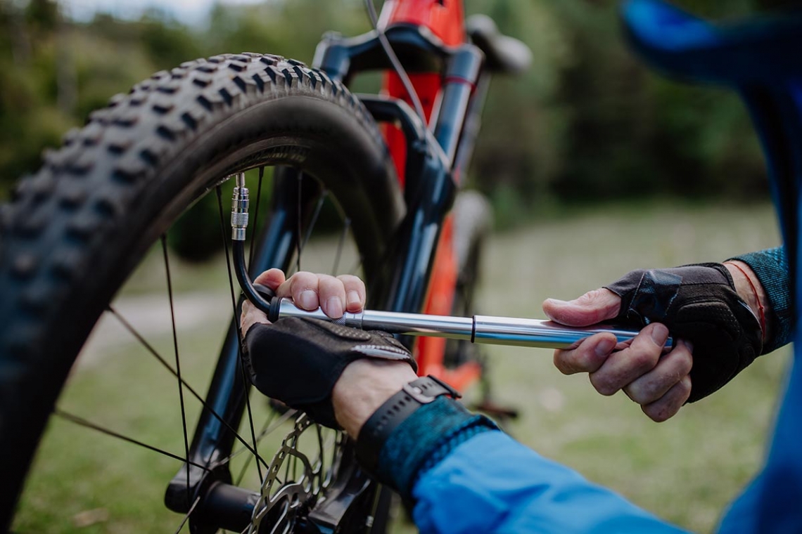 man pumping mountain bike tire.jpg